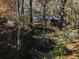 House nestled in woods, with visible shed and autumn leaves at 5375 Northland Ne Dr, Sandy Springs, GA 30342