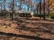 Brick ranch home with a front yard covered in autumn leaves at 5375 Northland Ne Dr, Sandy Springs, GA 30342