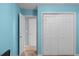 Light blue bedroom with double door closet and carpet at 1105 Huntcrest Rdg, Mcdonough, GA 30252