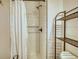 Updated bathroom with subway tile shower and shelving at 134 N Johnson N St, Newborn, GA 30056