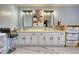 Double vanity bathroom with marble-look flooring and large mirrors at 134 N Johnson N St, Newborn, GA 30056