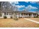 Ranch-style home with front porch and mature trees at 134 N Johnson N St, Newborn, GA 30056