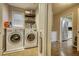 Bright laundry room with washer, dryer, and extra shelving at 134 N Johnson N St, Newborn, GA 30056