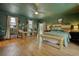 Spacious main bedroom with dark green walls, a wooden headboard, and hardwood floors at 134 N Johnson N St, Newborn, GA 30056