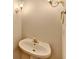 Small bathroom with pedestal sink and wall-mounted lights at 1924 Wilkenson Xing, Marietta, GA 30066