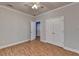 Bedroom with hardwood floors, double doors, and ceiling fan at 1924 Wilkenson Xing, Marietta, GA 30066