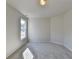 Sunlit bedroom with neutral walls and carpet, offering a window with a view at 1924 Wilkenson Xing, Marietta, GA 30066