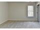 Spacious bedroom with neutral walls and carpet, featuring a large window and closet at 1924 Wilkenson Xing, Marietta, GA 30066