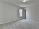 Simple bedroom with carpet flooring and a large window at 1924 Wilkenson Xing, Marietta, GA 30066