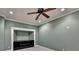 Finished bonus room with built-in shelving and ceiling fan at 1924 Wilkenson Xing, Marietta, GA 30066