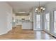 Sunlit dining room features hardwood floors and chandelier at 1924 Wilkenson Xing, Marietta, GA 30066