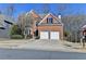 Brick house with two-car garage and landscaped yard at 1924 Wilkenson Xing, Marietta, GA 30066