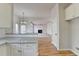 Kitchen with granite countertops, white cabinets and views into Gathering room at 1924 Wilkenson Xing, Marietta, GA 30066