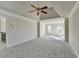 Spacious main bedroom with tray ceiling, ceiling fan, and carpet flooring at 1924 Wilkenson Xing, Marietta, GA 30066