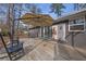 A wooden back deck featuring stylish decor and an adjustable sunshade umbrella at 3413 Canadian Way, Tucker, GA 30084