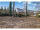 Mature trees surround the backyard with a shed and a glimpse of neighboring houses at 3413 Canadian Way, Tucker, GA 30084