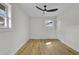 Bedroom featuring wood floors and walls painted white with modern ceiling fan at 3413 Canadian Way, Tucker, GA 30084