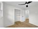 Bright bedroom featuring hardwood floors, ceiling fan, and closet with shelving at 3413 Canadian Way, Tucker, GA 30084