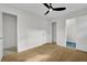 Sunlit bedroom showcasing hardwood floors, open closet, and adjacent bathroom entrance at 3413 Canadian Way, Tucker, GA 30084