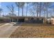 Charming single-story home featuring a covered carport, a long driveway and freshly painted exterior at 3413 Canadian Way, Tucker, GA 30084