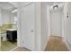 Hallway leading to bathroom with modern vanity and mirror at 3413 Canadian Way, Tucker, GA 30084