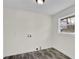 Empty laundry room shows washer/dryer hookups and wood-look vinyl floors at 3413 Canadian Way, Tucker, GA 30084