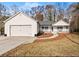 White house with attached garage, landscaping, and walkway at 6045 Mockingbird Rd, Cumming, GA 30028