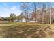 Ranch home with a large yard, trees, and a clear view at 6045 Mockingbird Rd, Cumming, GA 30028