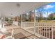 Relaxing front porch with white railings and wooded views at 6045 Mockingbird Rd, Cumming, GA 30028