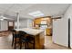 Small kitchen with wood cabinets and breakfast bar at 6045 Mockingbird Rd, Cumming, GA 30028