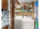 Basement laundry room with washer, dryer and shelving at 6045 Mockingbird Rd, Cumming, GA 30028