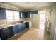 Kitchen with blue cabinets, tiled floor, and a back door at 1351 Harbin Rd, Atlanta, GA 30311