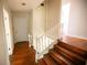 Classic wooden staircase with white railings leading to the second floor at 1351 Harbin Rd, Atlanta, GA 30311