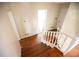 Wooden staircase with white railings connecting floors at 1351 Harbin Rd, Atlanta, GA 30311