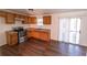 Simple kitchen with wood cabinets, stainless steel appliances, and vinyl flooring at 2761 Rockdale, Decatur, GA 30034