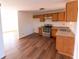 Eat-in kitchen with wood cabinets, stainless steel appliances, and vinyl flooring at 2761 Rockdale, Decatur, GA 30034