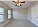 Well-lit bedroom with ceiling fan and carpeting at 4323 Tacoma Trce, Suwanee, GA 30024