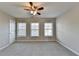 Spacious bedroom with ceiling fan and multiple windows at 4323 Tacoma Trce, Suwanee, GA 30024