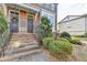 Brick steps leading to double front doors of townhome with railings and landscaping at 4323 Tacoma Trce, Suwanee, GA 30024