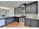 Spacious kitchen with dark cabinetry, granite countertops, and stainless steel appliances at 4323 Tacoma Trce, Suwanee, GA 30024