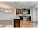 Modern kitchen with dark cabinets, granite counters, and stainless steel appliances at 4323 Tacoma Trce, Suwanee, GA 30024