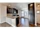 Open kitchen with dark cabinets, granite island, and stainless steel appliances at 4323 Tacoma Trce, Suwanee, GA 30024