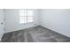 Bright bedroom with gray carpeting and large window at 476 Cody Ln, Douglasville, GA 30134