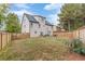 Large backyard with grassy area, wooden fence, and home view at 1411 Splitrock Sw Pl, Atlanta, GA 30331