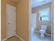 View of a bathroom with a shower-tub combo, a toilet, and a window at 1411 Splitrock Sw Pl, Atlanta, GA 30331