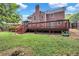 Brick house with large deck and grassy backyard at 1450 Grovehurst Dr, Marietta, GA 30062