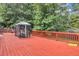 Red wooden deck with gazebo and swing set at 1450 Grovehurst Dr, Marietta, GA 30062