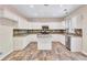 Kitchen with white cabinets, granite island and tile floor at 1450 Grovehurst Dr, Marietta, GA 30062