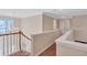 Upstairs hallway with wood railing, carpet, and chandelier at 1450 Grovehurst Dr, Marietta, GA 30062