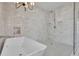 Bathroom with walk-in shower, soaking tub, and white tile at 1565 Pineview Terrace Sw, Atlanta, GA 30311